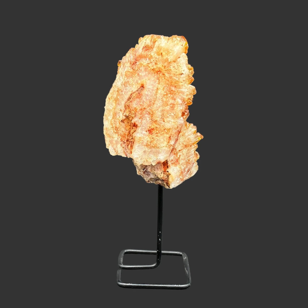 Right side of this citrine on stand, in front of a black background.