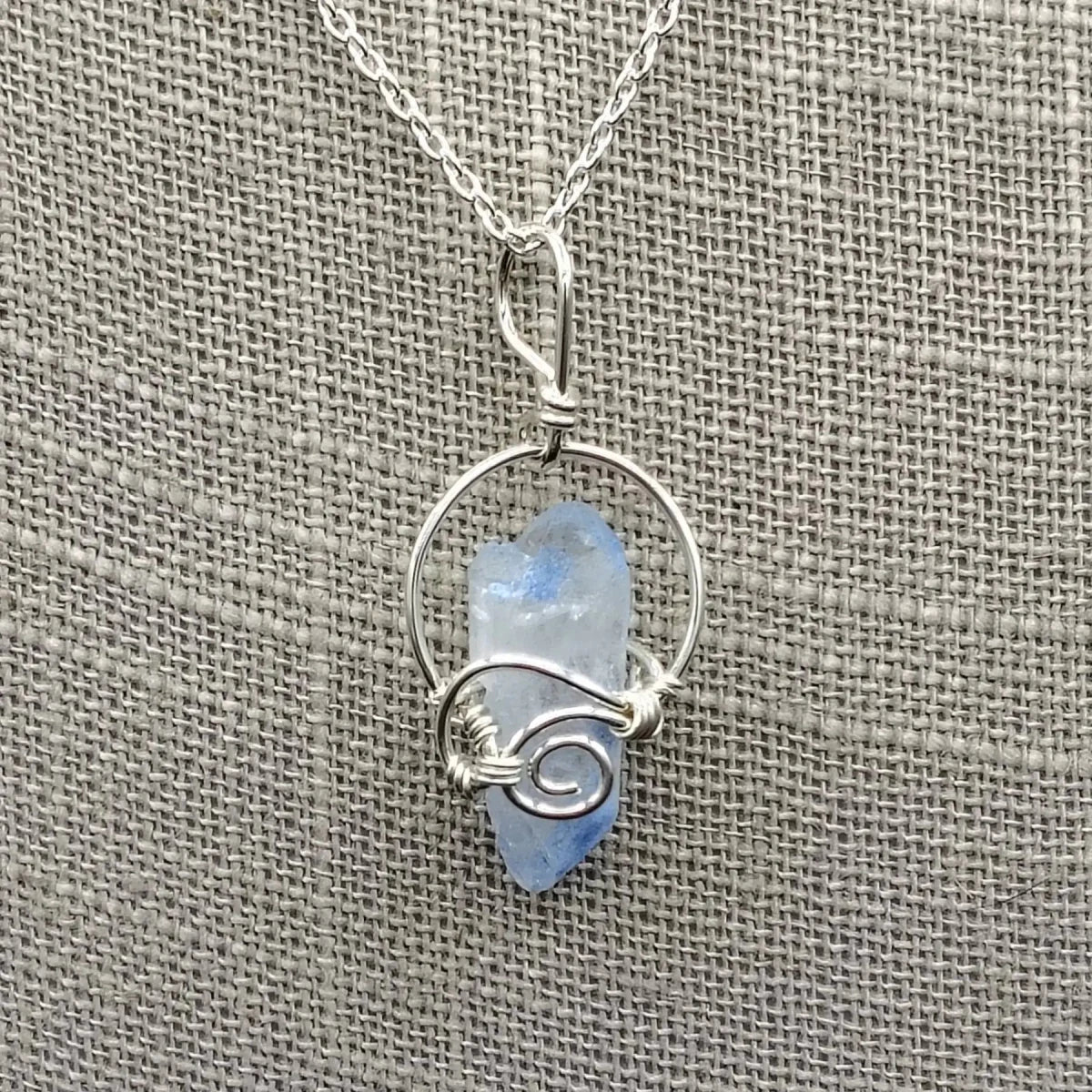 This is a close up of the Sterling Silver wire wrapped blue Dumotierite crystal pendant