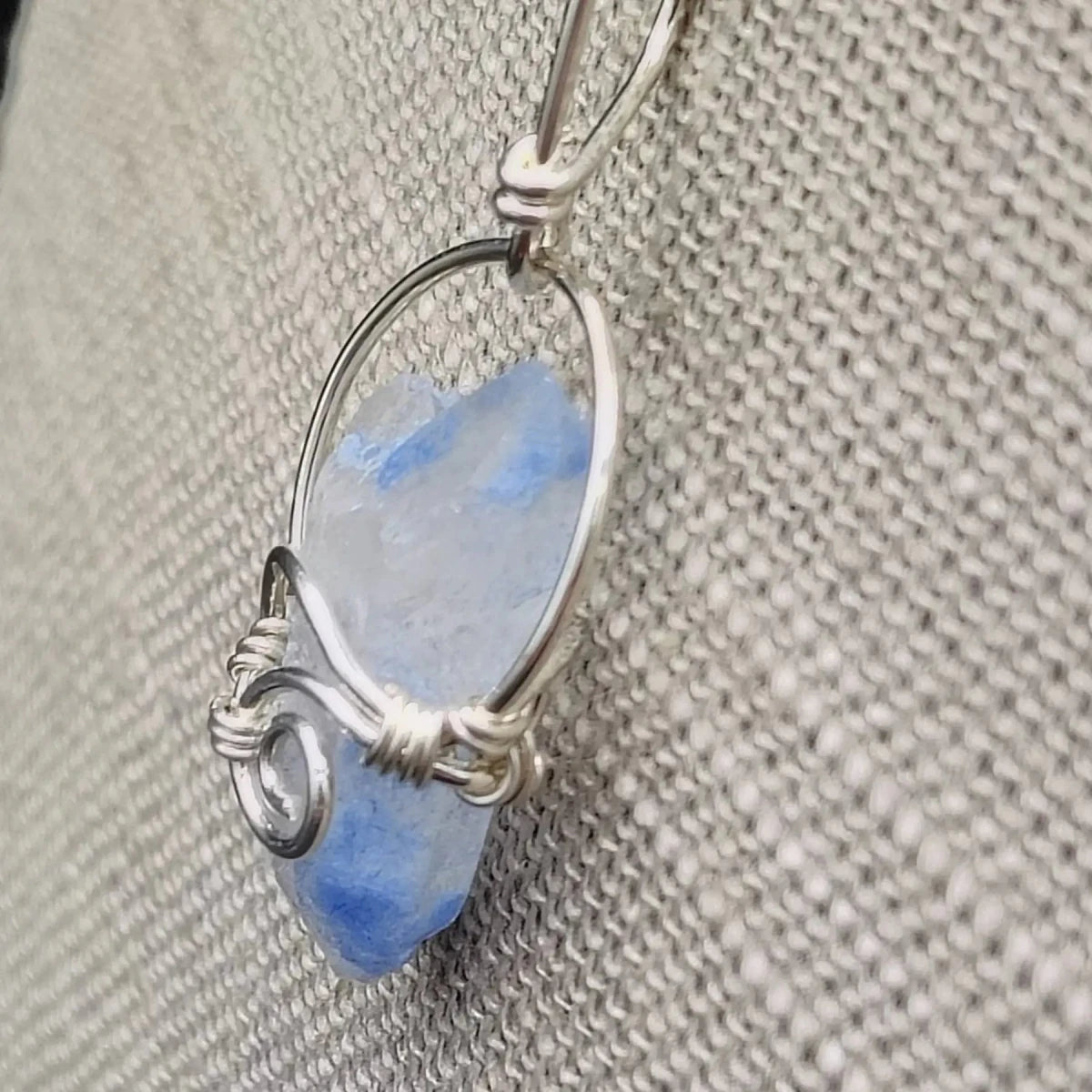 This is the side view of this Sterling Silver wire wrapped blue Dumotierite crystal pendant