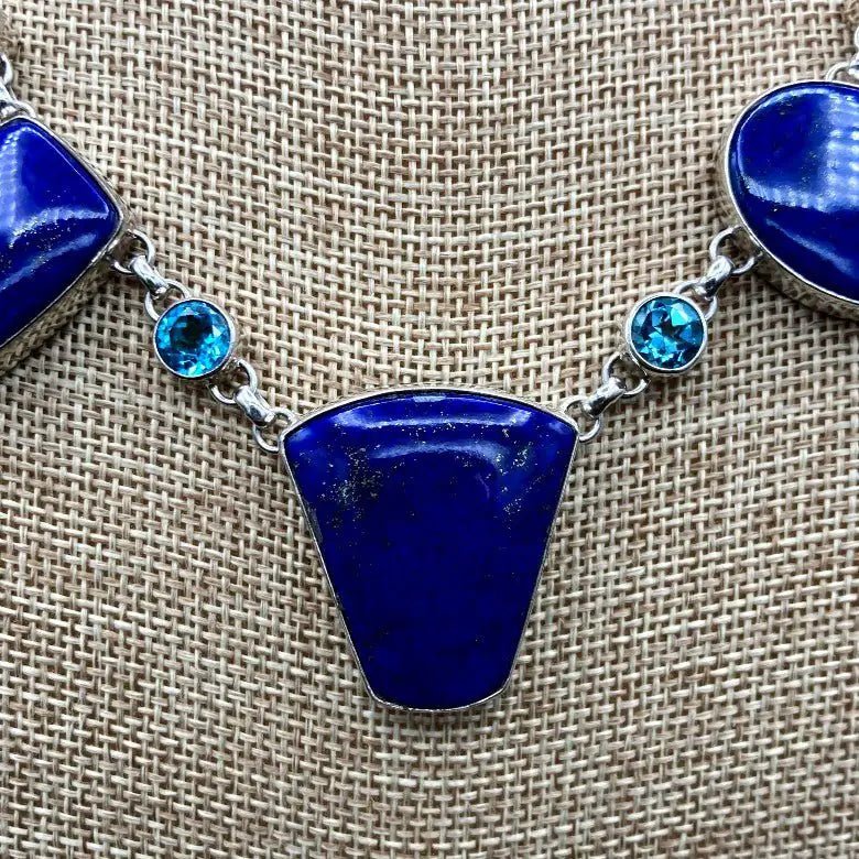 Blue Stones On A Link Necklace With Beige Background