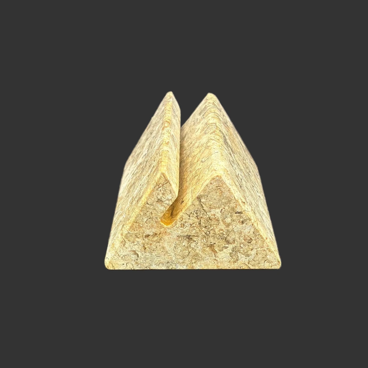 Side view of this fossil onyx card holder, in front of a black background.