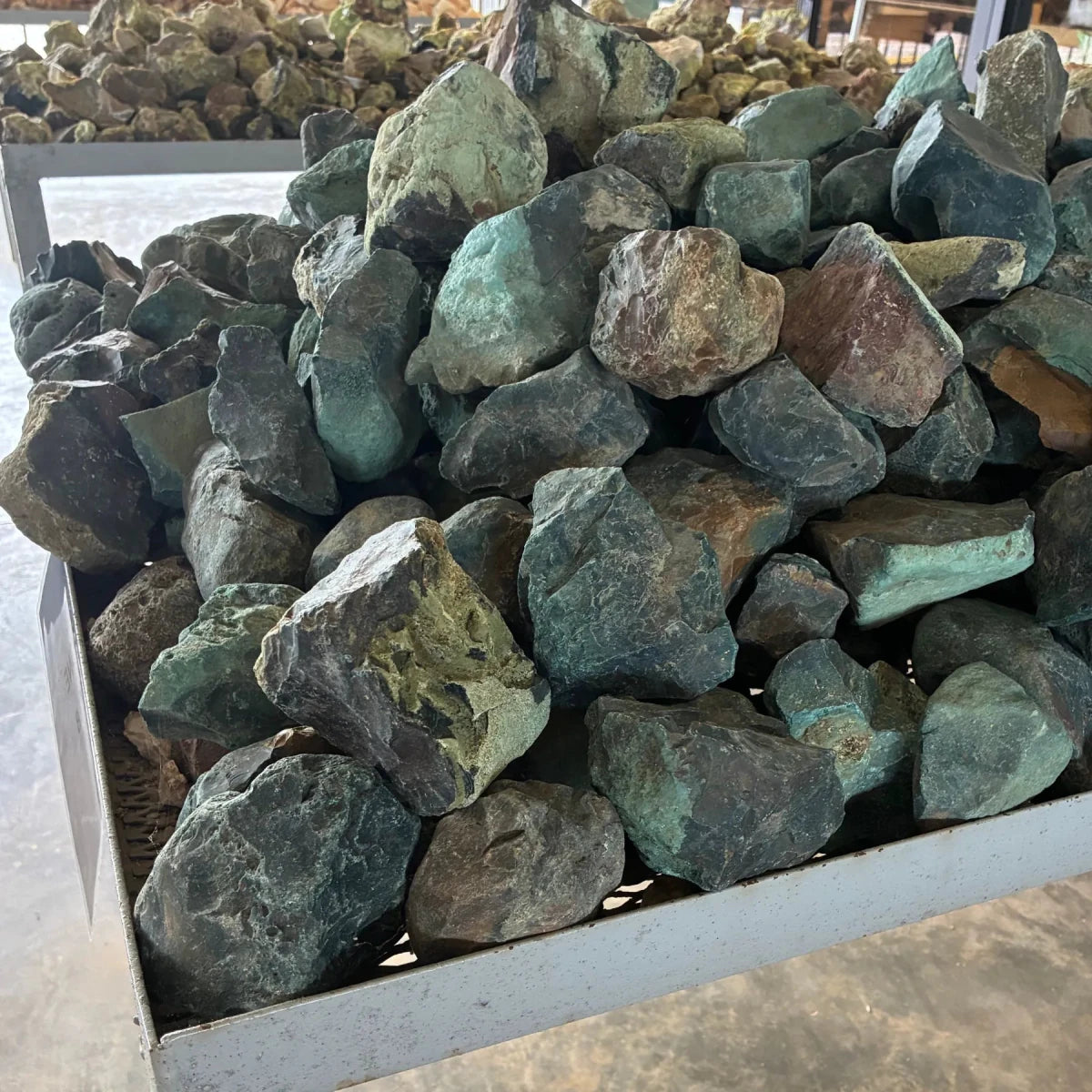 Side view of green bloodstone on a table outdoors.