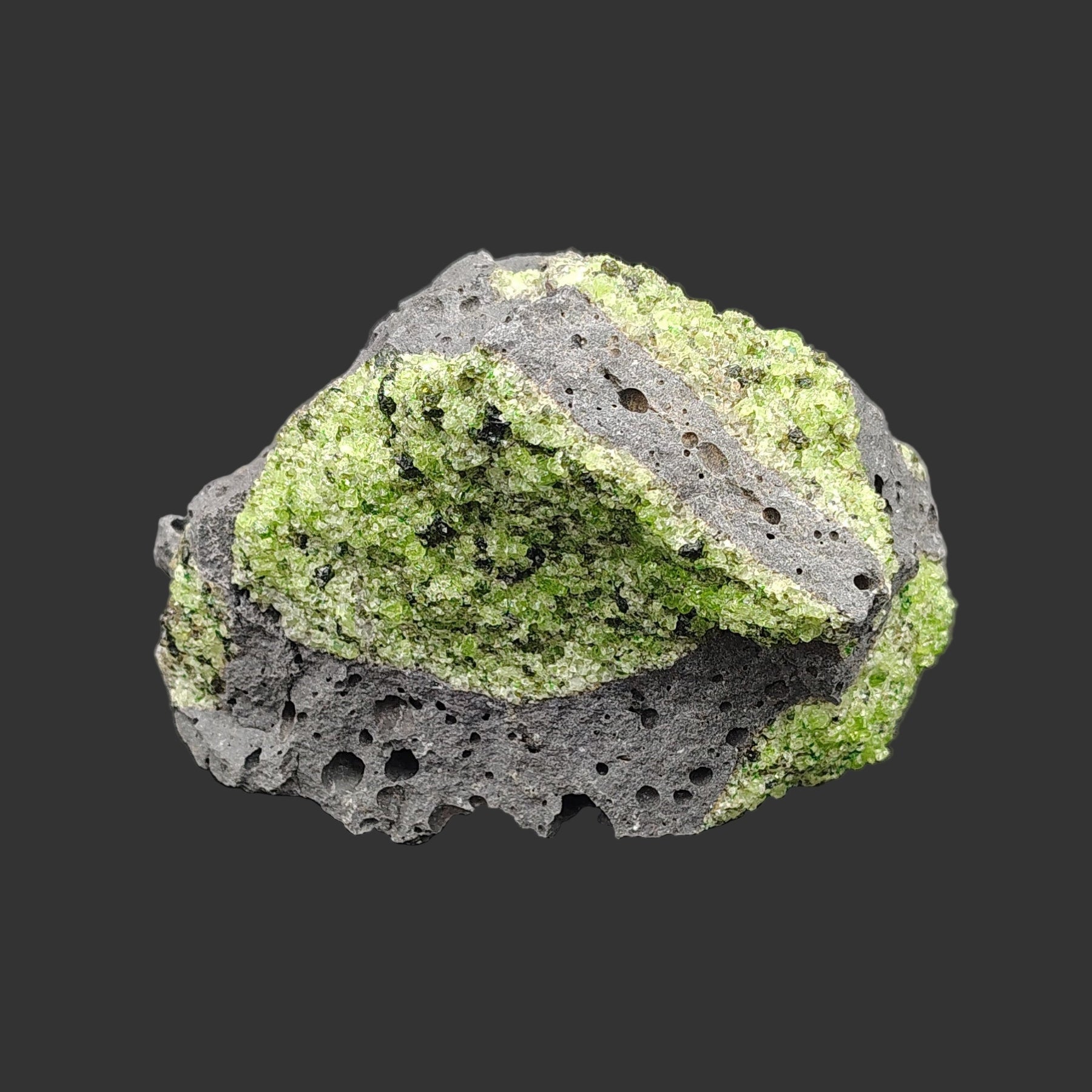 This is a close up of a single piece of raw natural Peridot.