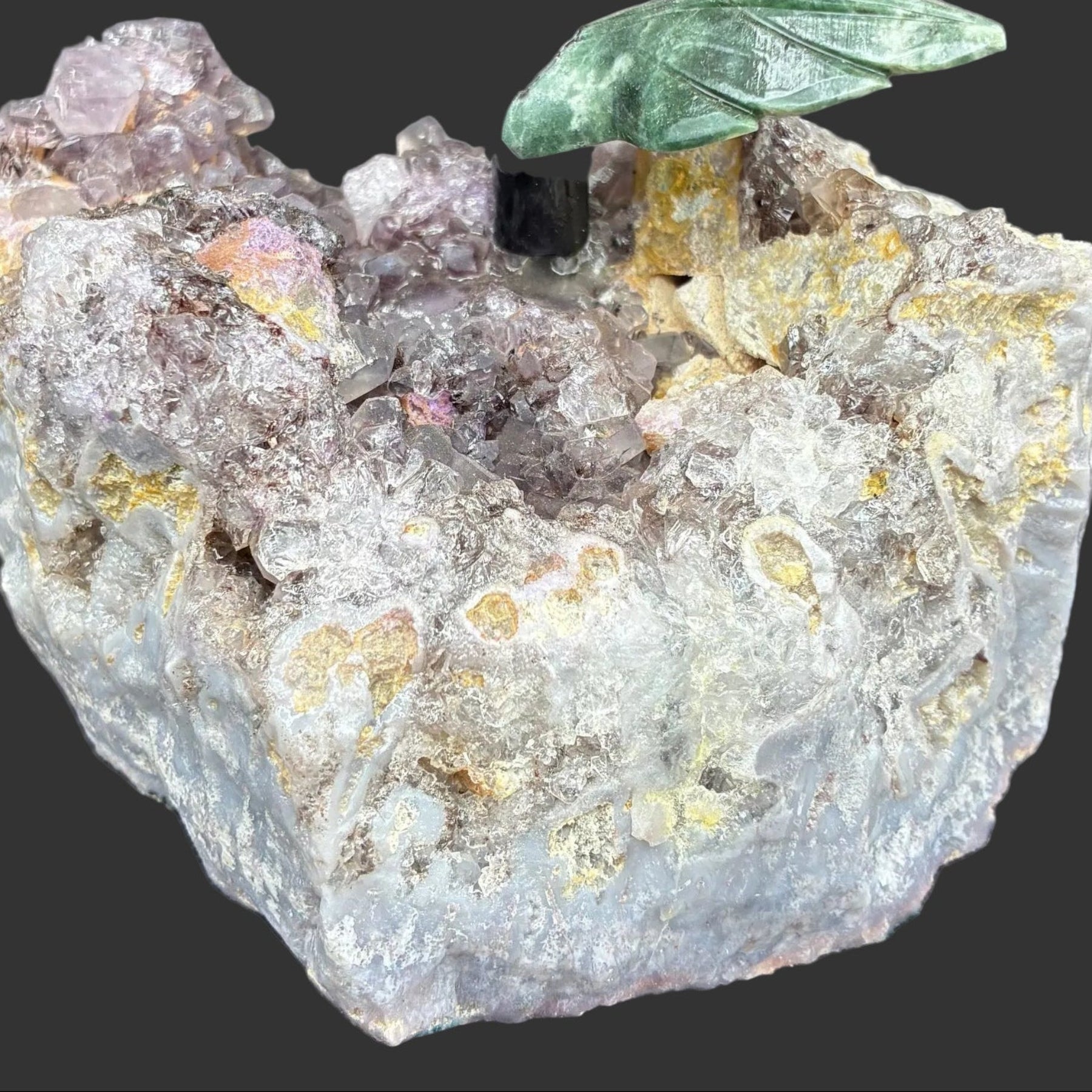 Close up of the raw Amethyst base, on a black surface.