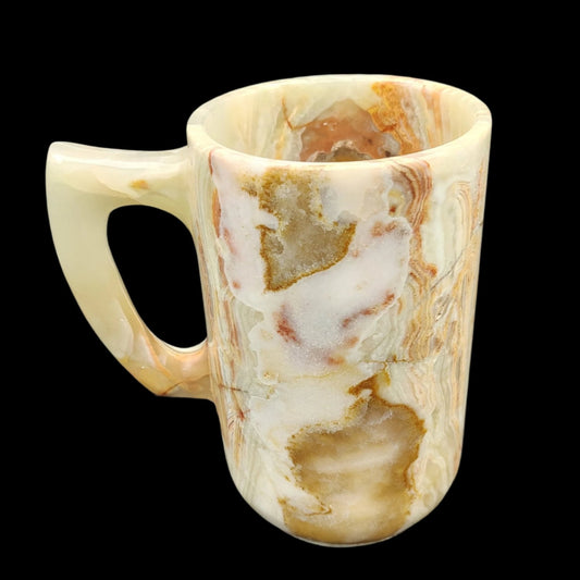 This is the left side of this large Onyx mug showing the handle that is mostly light green and the natural stone color pattern is white, brown, green