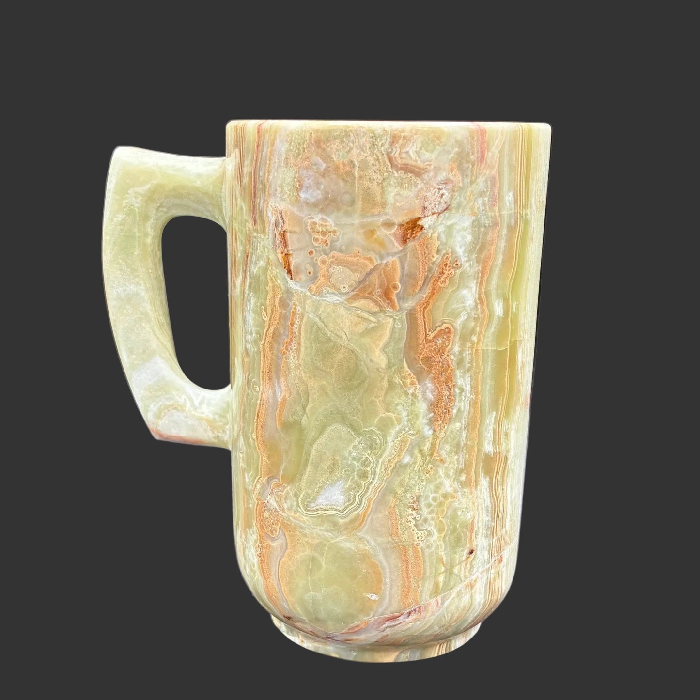 This is the right side of this multi-colored Onyx mug in front of a black background.