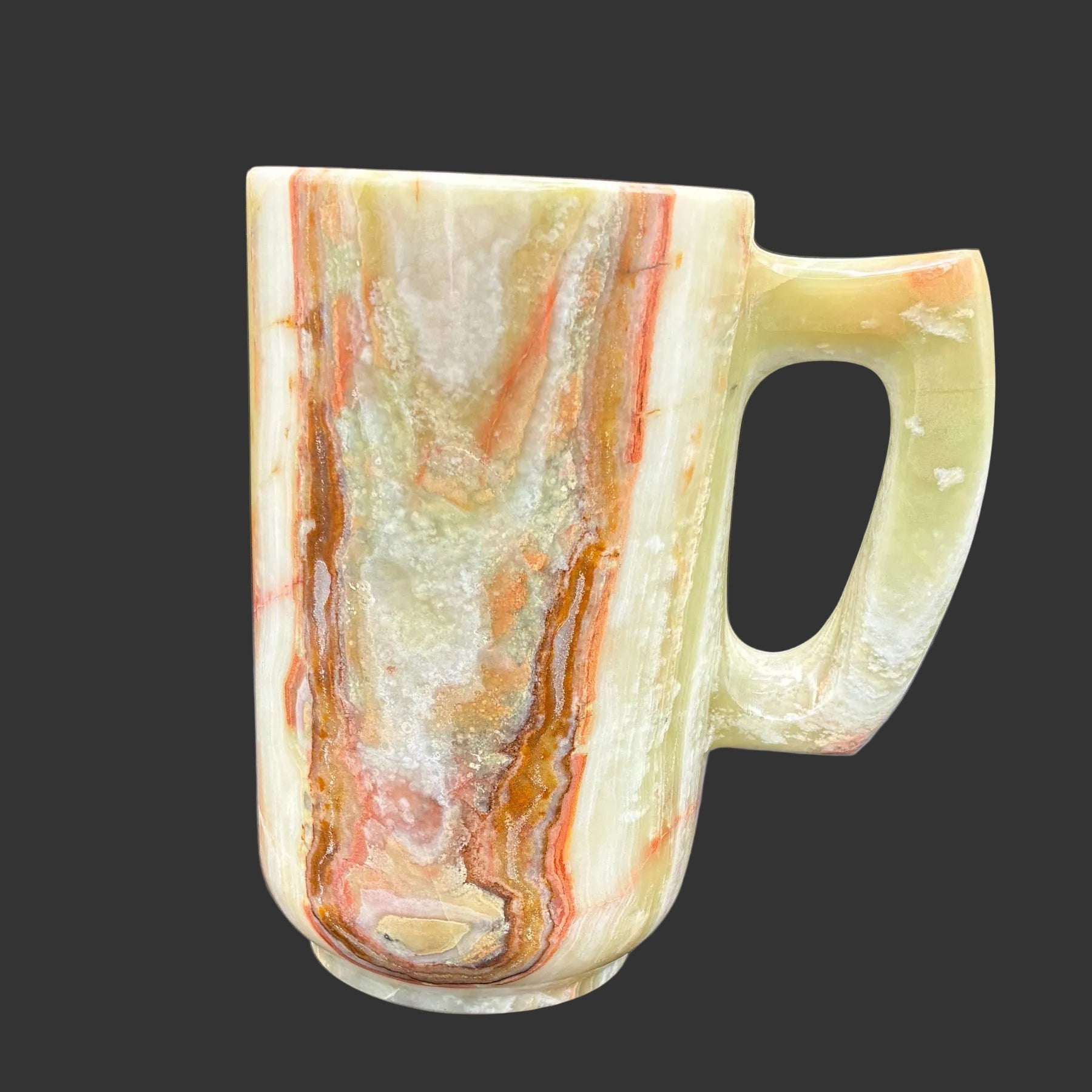 This is the left side of this multi-colored Onyx mug in front of a black background.