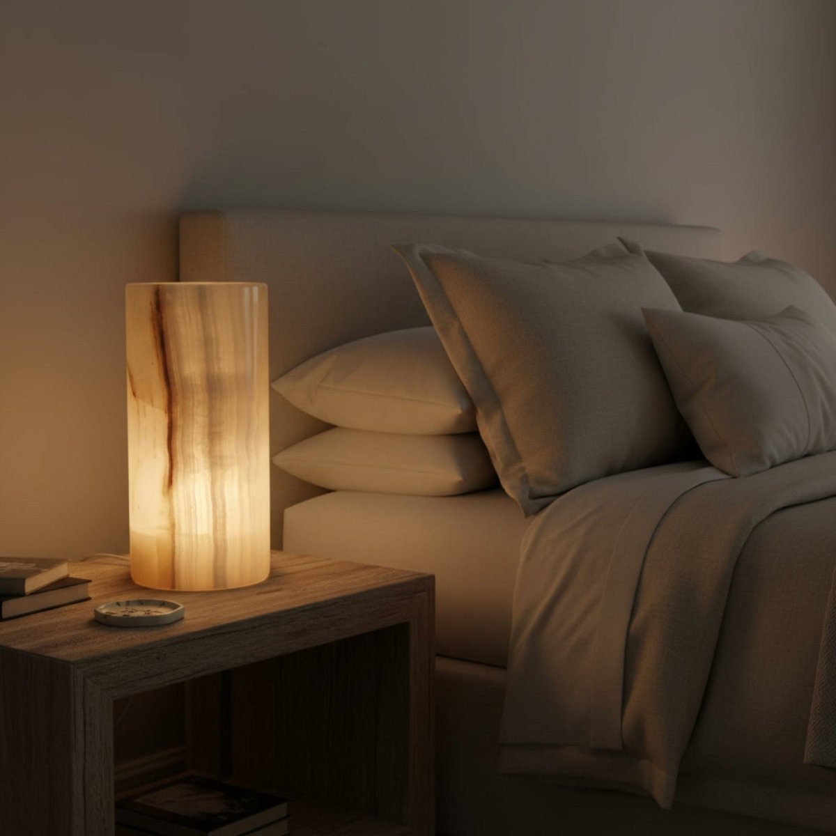 Round Onyx cylinder lamp on a bedside table, in a dim lite bedroom.
