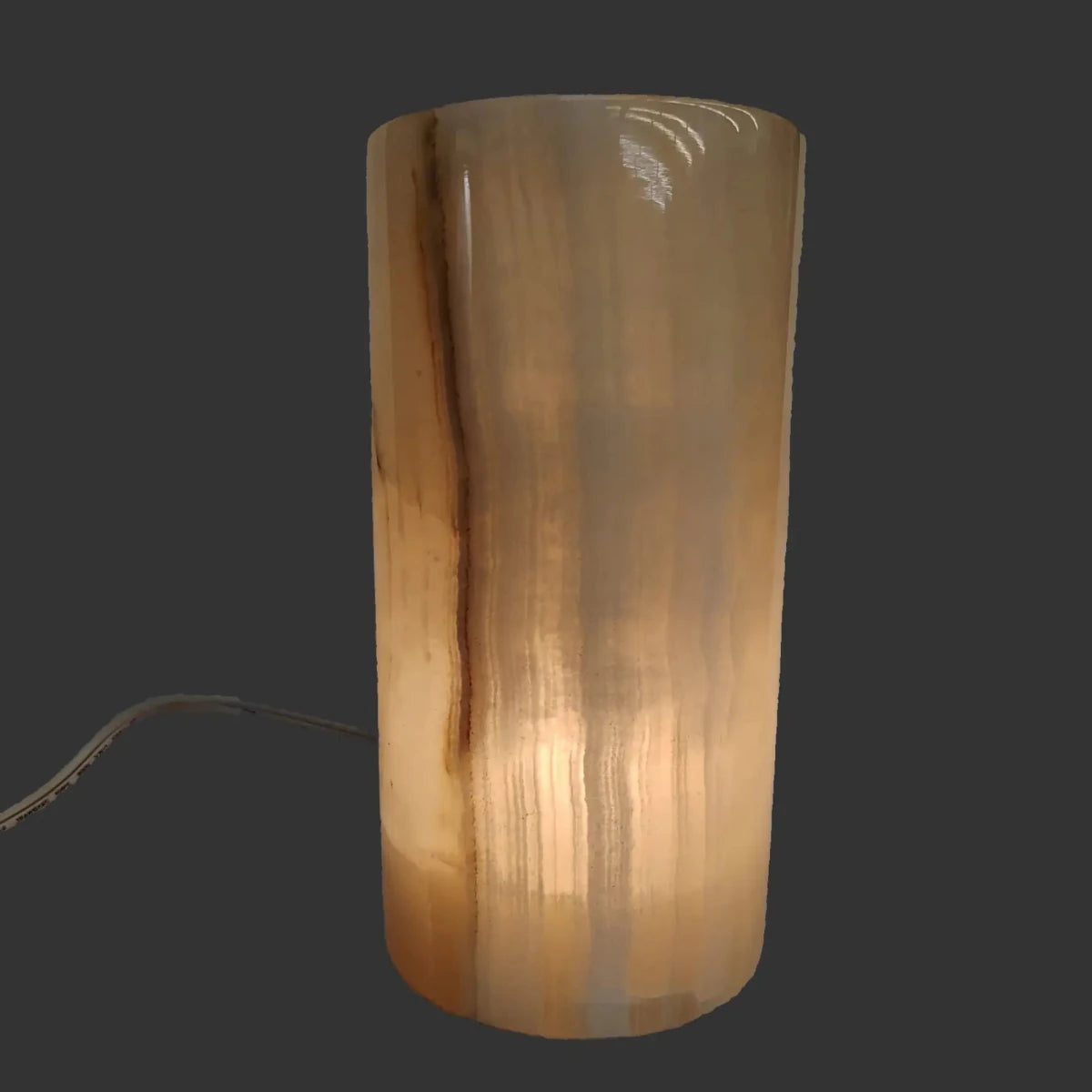 This is the cream-colored Onyx table lamp with the lamp turned on.