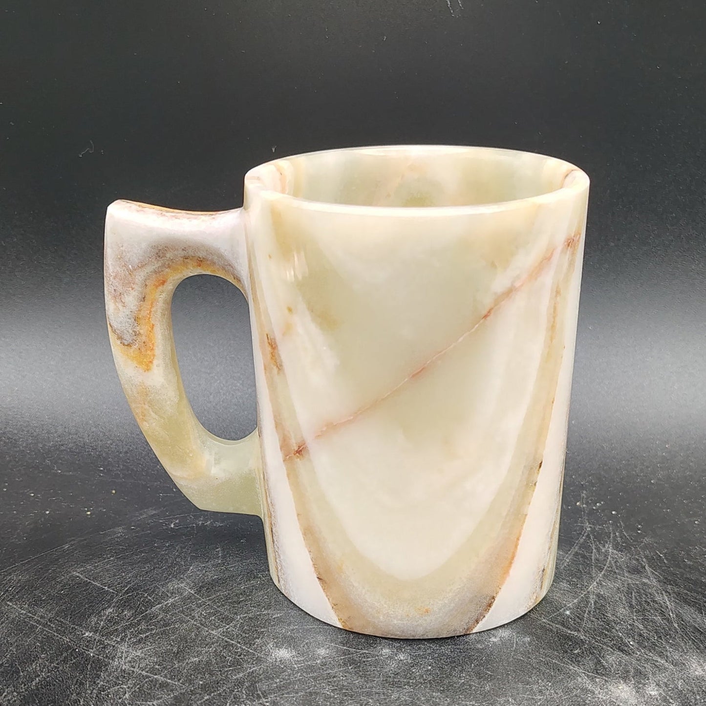 This is the right side of this Onyx mug, mostly cream, with some brown and green.