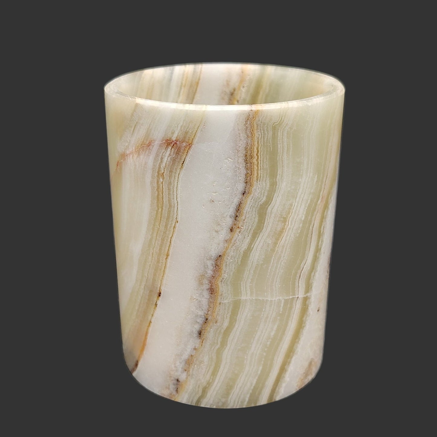 This is the front view of this Onyx mug. It has banding of green, brown, orange, and cream Onyx.