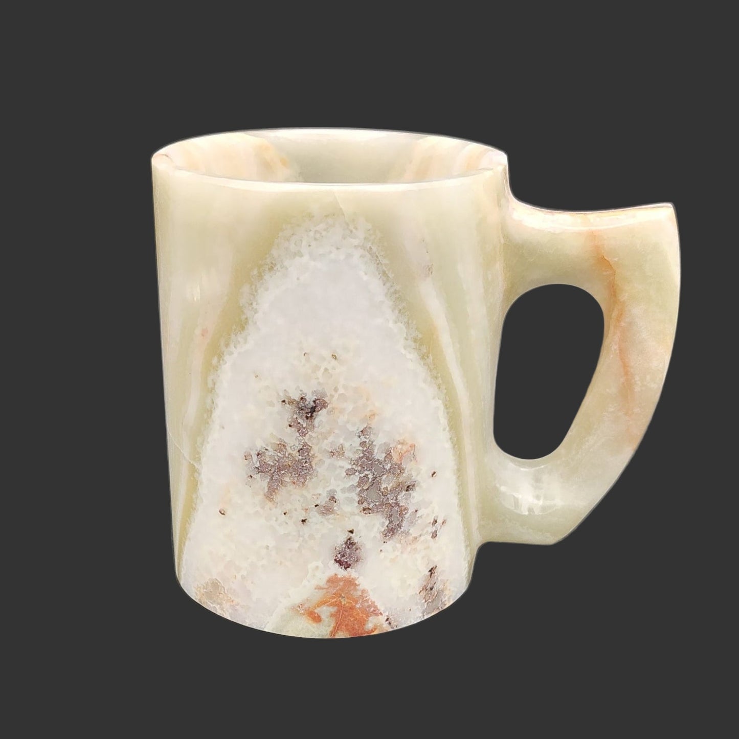 This is the left side of this polished mug, mostly cream, but has some green, orange, and gray.