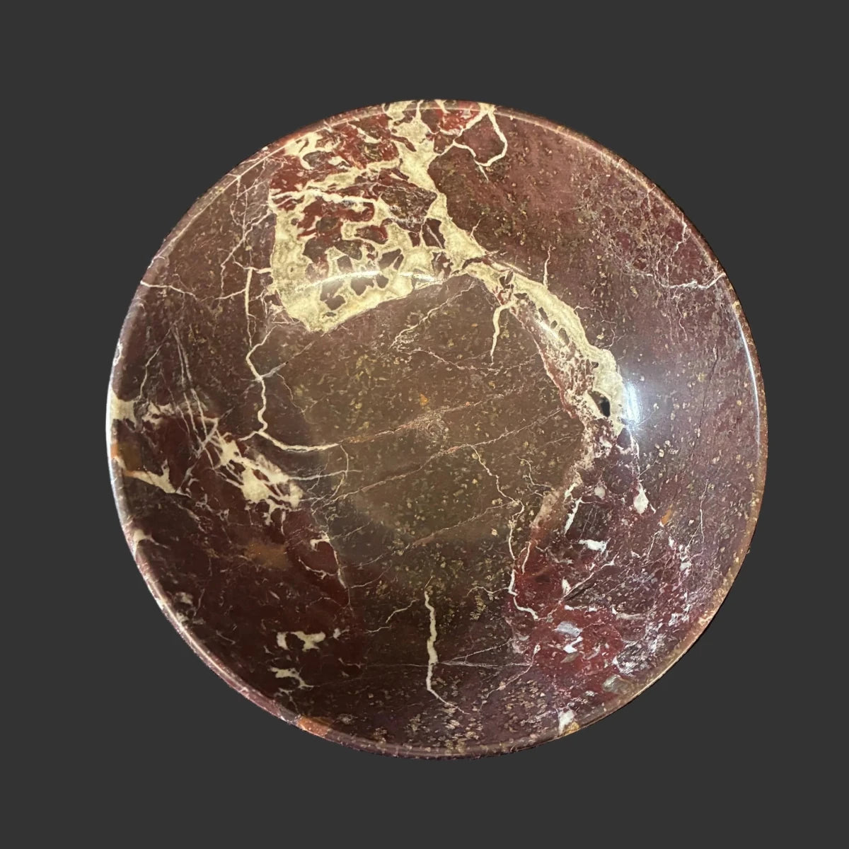 Top view of this red onyx bowl in front of a black background.