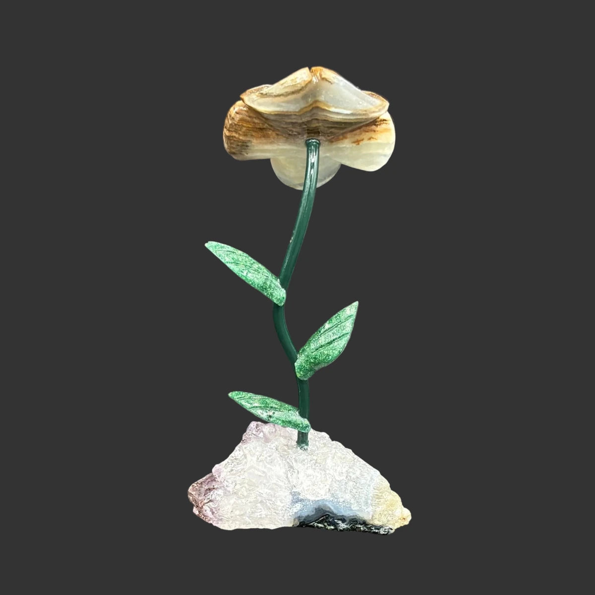 Back side of this blue onyx flower on a amethyst base, in front of a black background.
