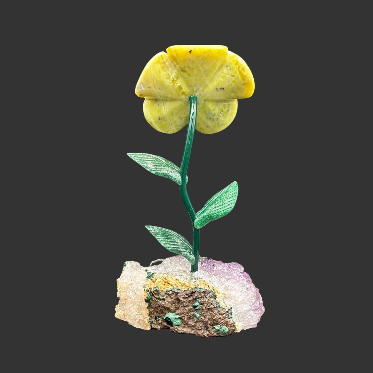 Back side of this green opal flower, in front of a black background.
