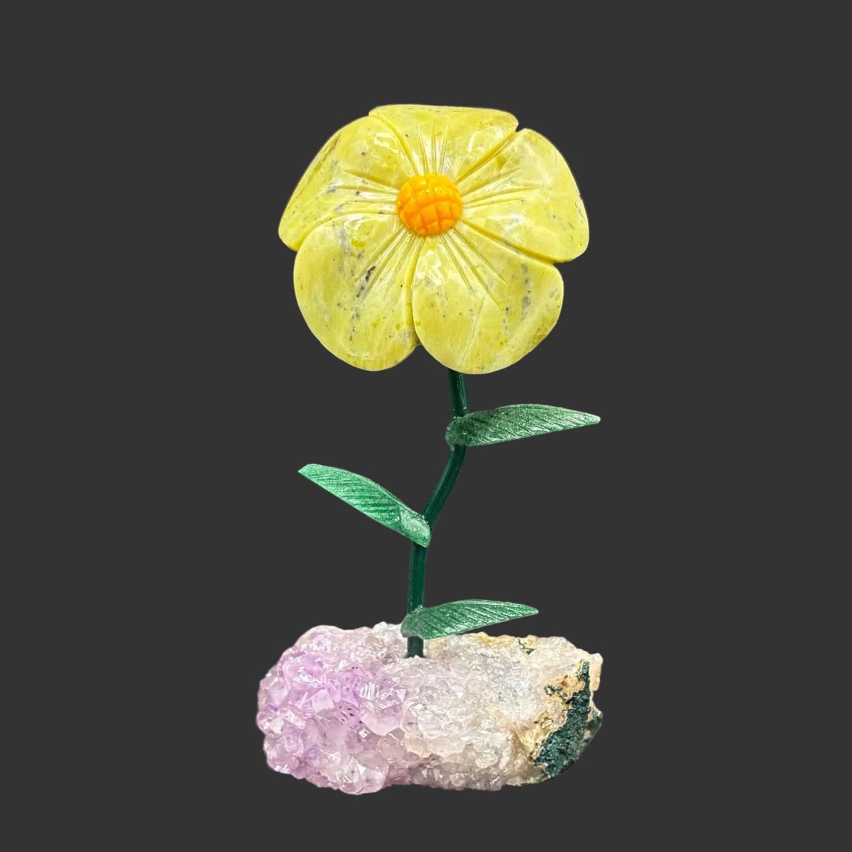 Front side of this green opal on a amethyst crystal base, in front of a black background.