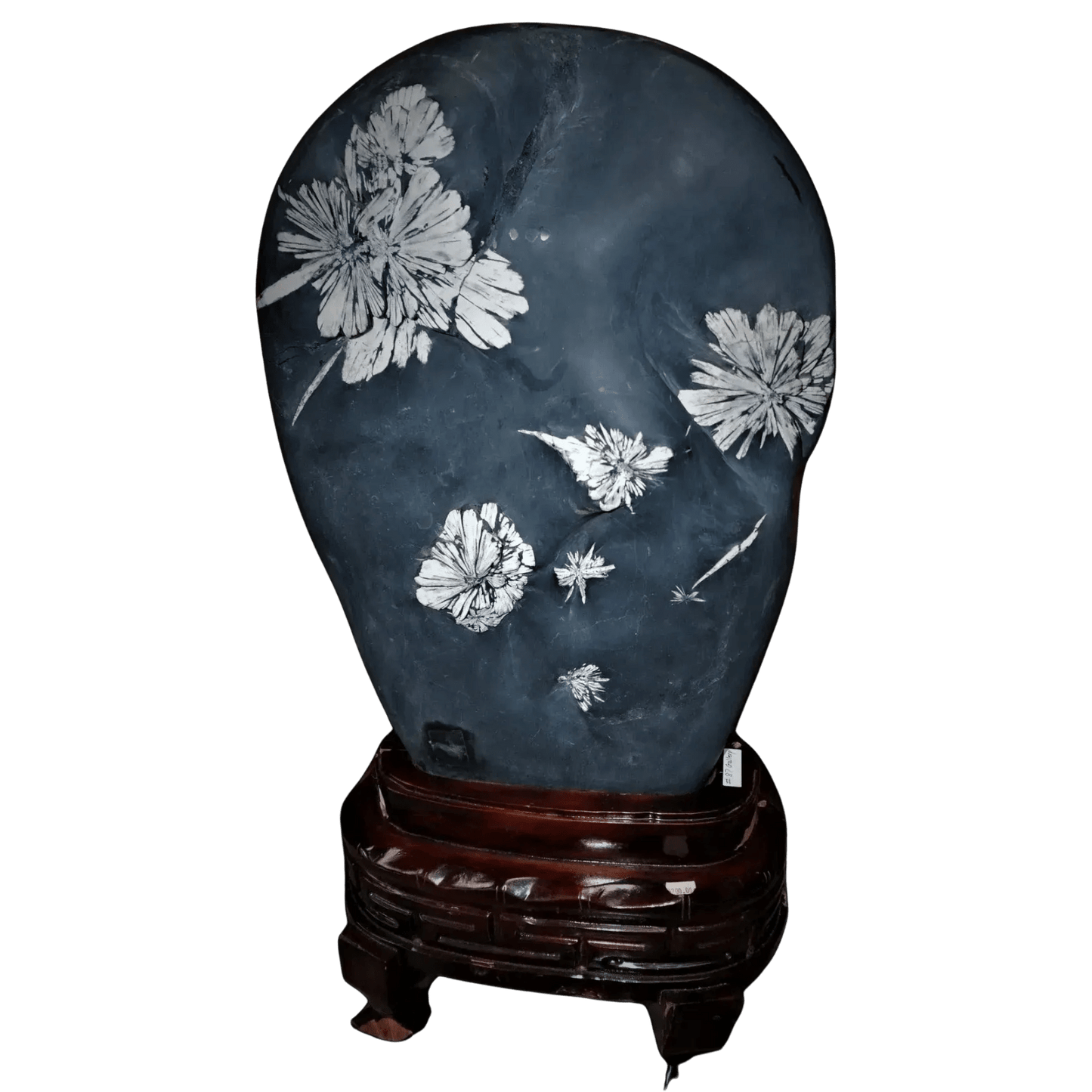 Decorative stone with floral carvings on a wooden stand against a white background