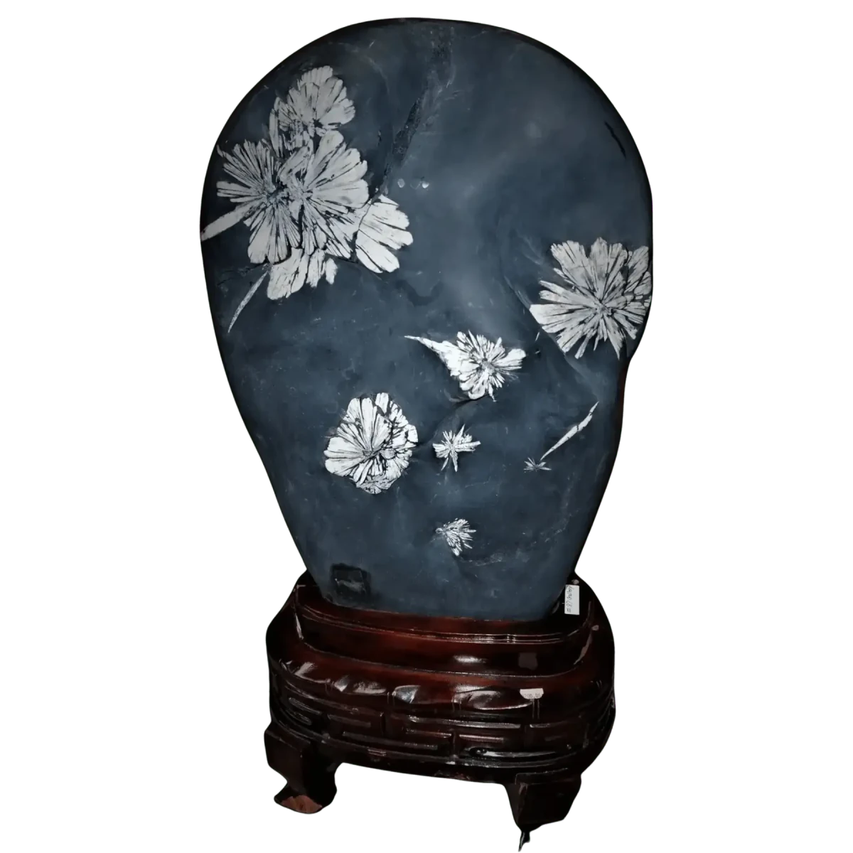 Decorative stone with floral carvings on a wooden stand against a white background