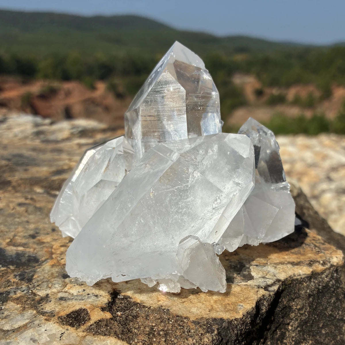 Back side of this quartz crystal cluster, on a rock outdoors.
