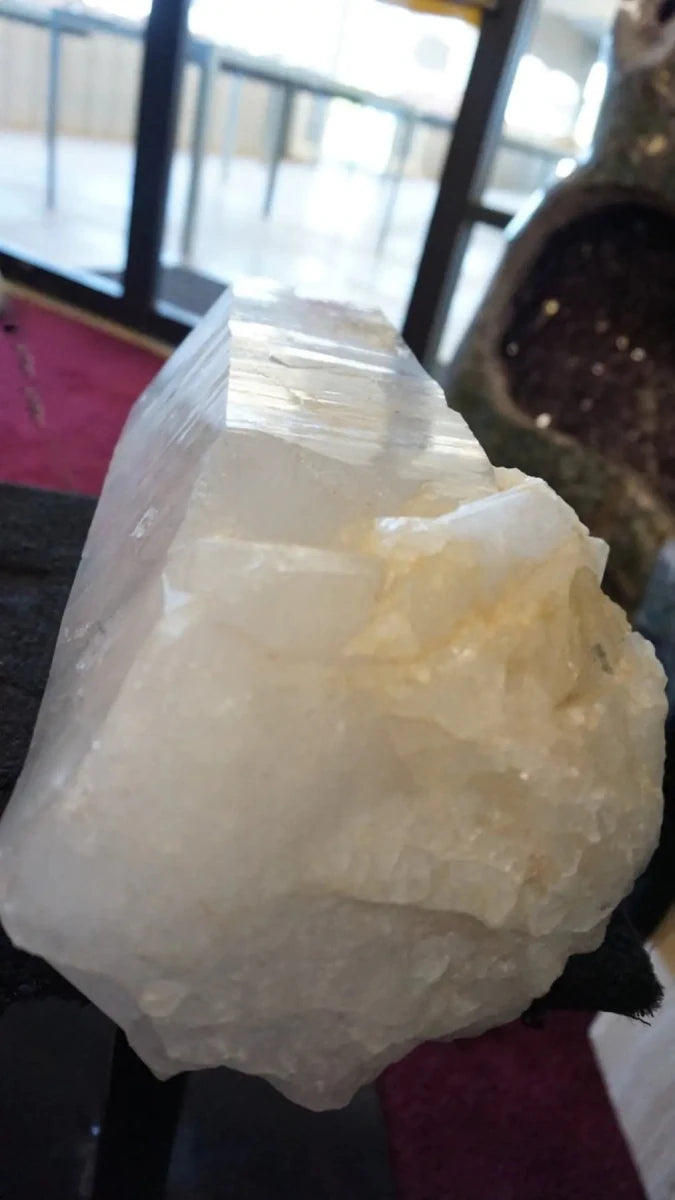 Large crystal rock on a black surface showing the bottom