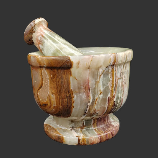 This is the front view of this large, banded Onyx mortar and pestle, brown, cream, and green in color.