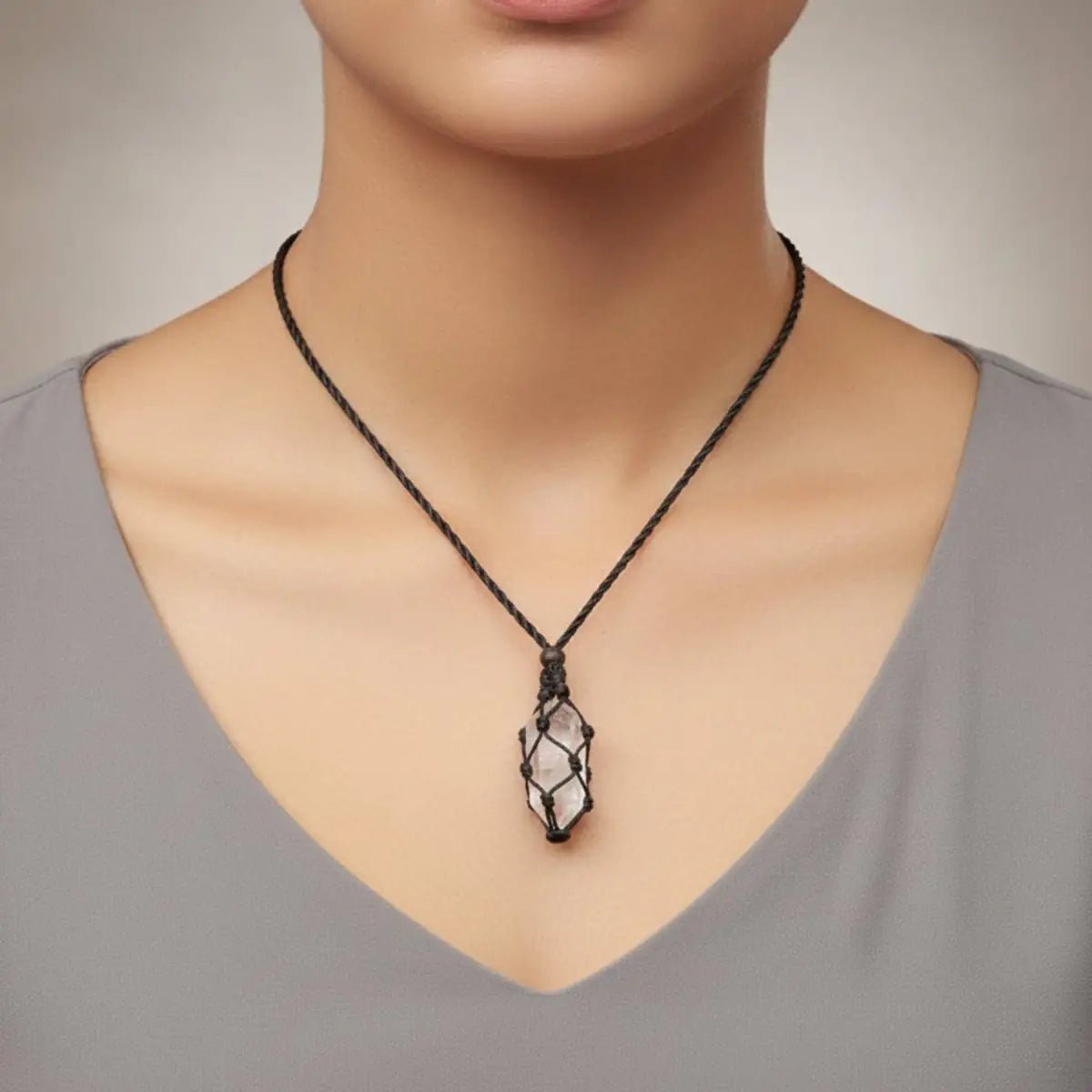  lady wearing a cord necklace with quartz crystal point.