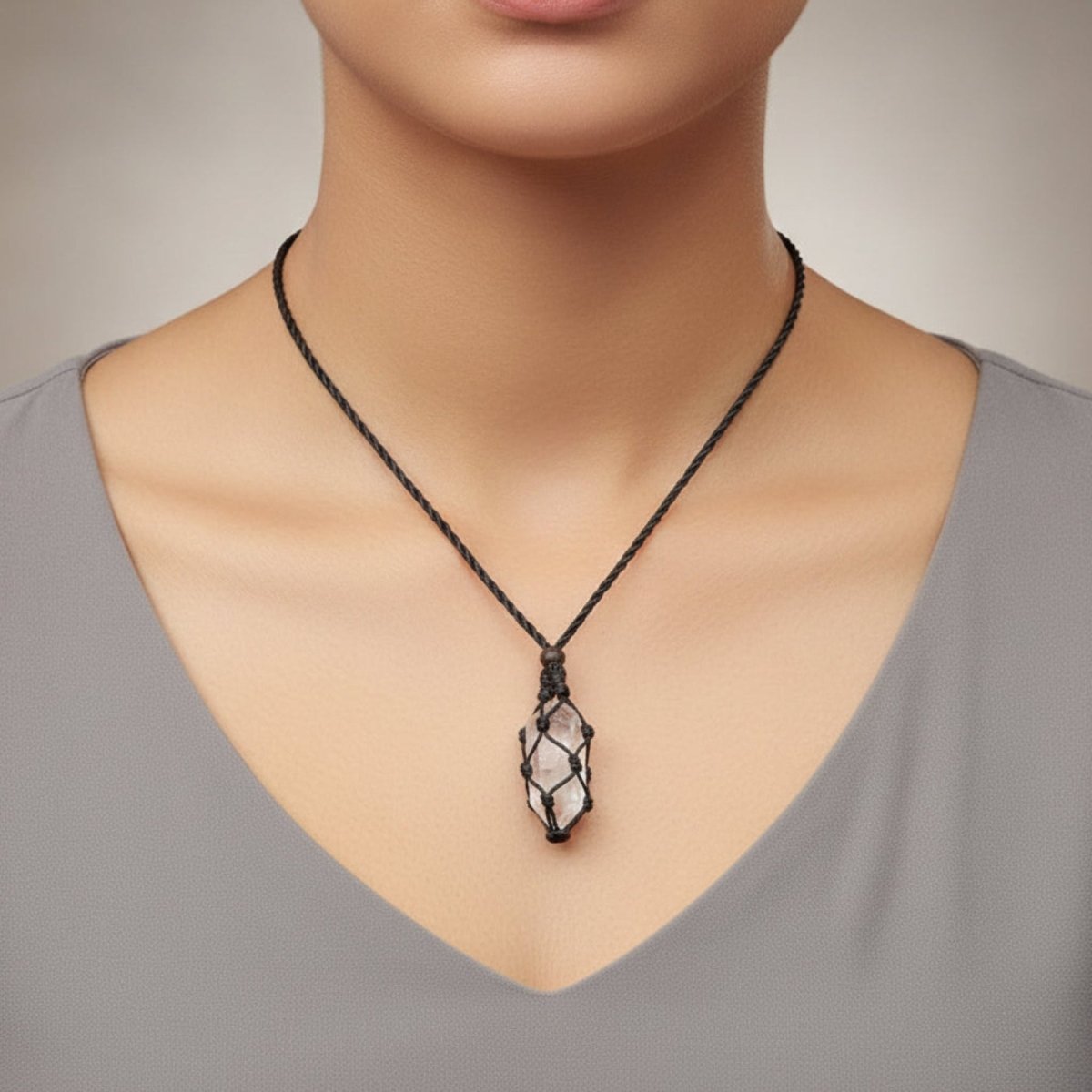  lady wearing a cord necklace with quartz crystal point.