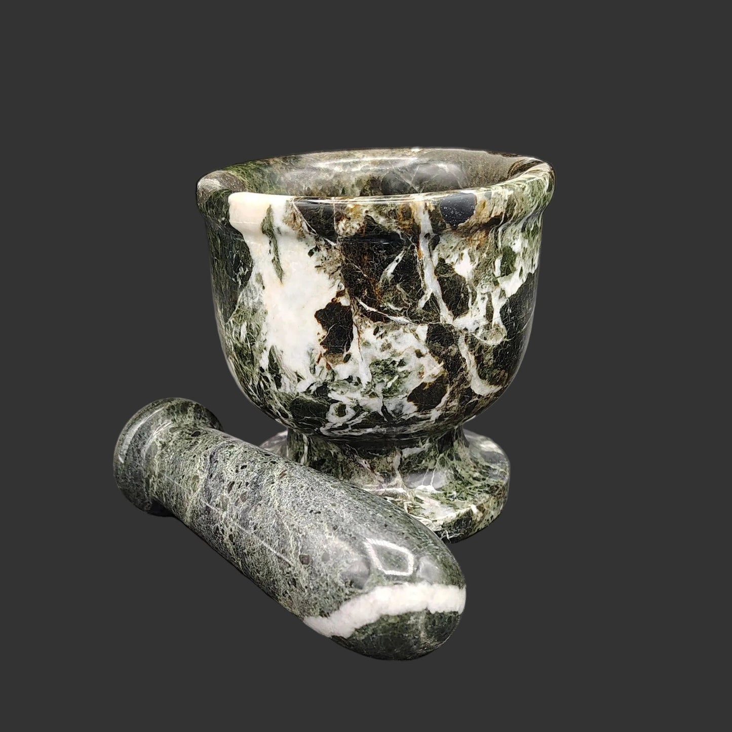 A better view of the pestle with the mortar. Dark green and white in color.
