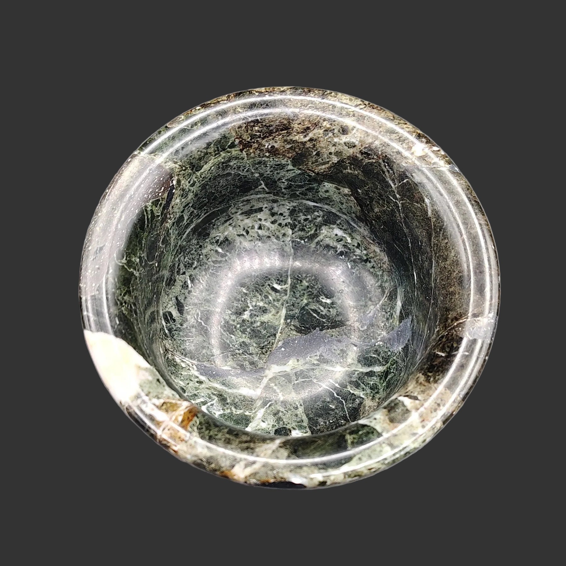The inside of this Onyx mortar is polished and dark green, brown, and white in color.