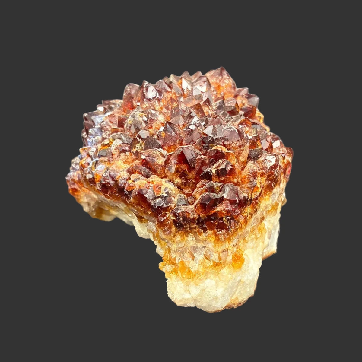 Back side view of this citrine specimen, in front of a black background.