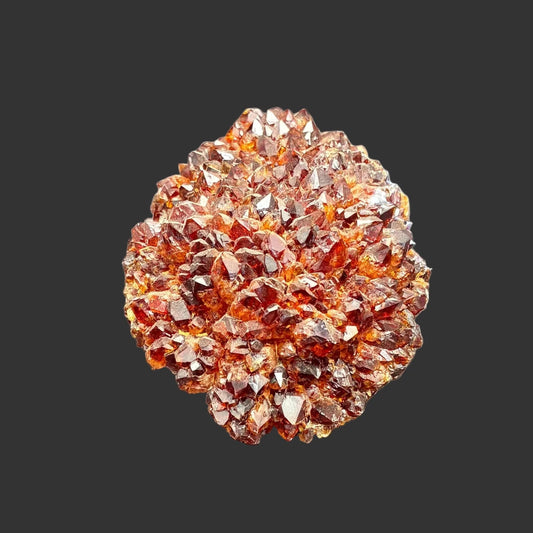 Front view of this dark honey colored citrine specimen, in front of a black background.