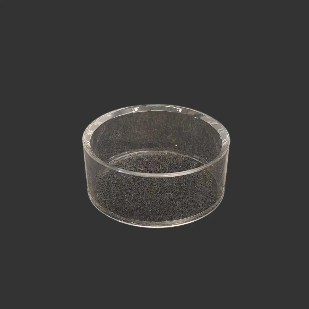 This acrylic riser display stand is clear, glossy, and round in shape.