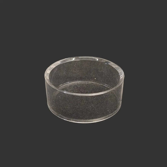 This acrylic riser display stand is clear, glossy, and round in shape.
