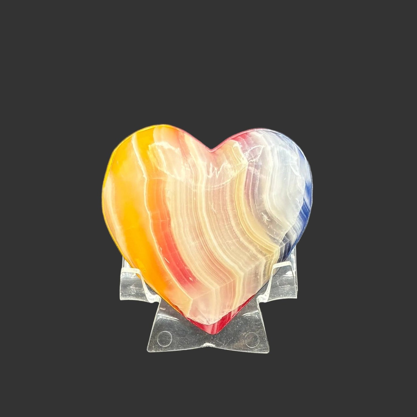This is the clear acrylic easel display stand, with a mineral heart palm stone cradled onto the arms.