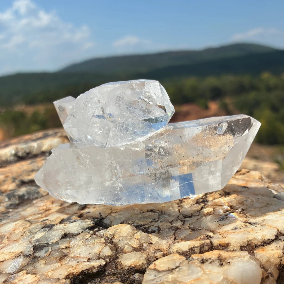 Back side of this quartz crystal cluster, on a boulder outdoors.