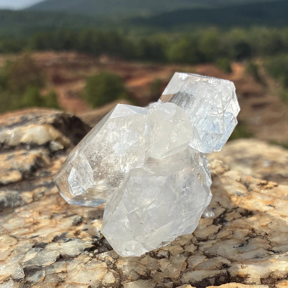 Left side of this double-terminated quartz cluster, on a boulder outdoors.