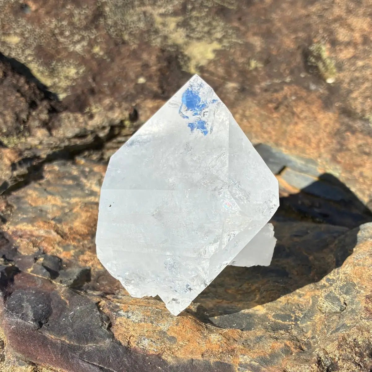 Left-top view of this double terminated quartz crystal point, on a rock outdoors.