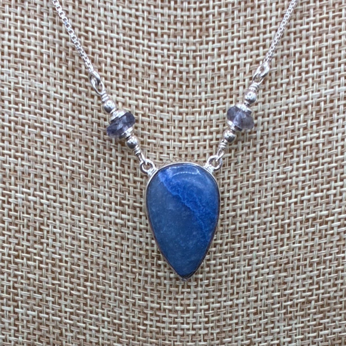 Close up of the dumortierite and iolite on this sterling silver necklace.