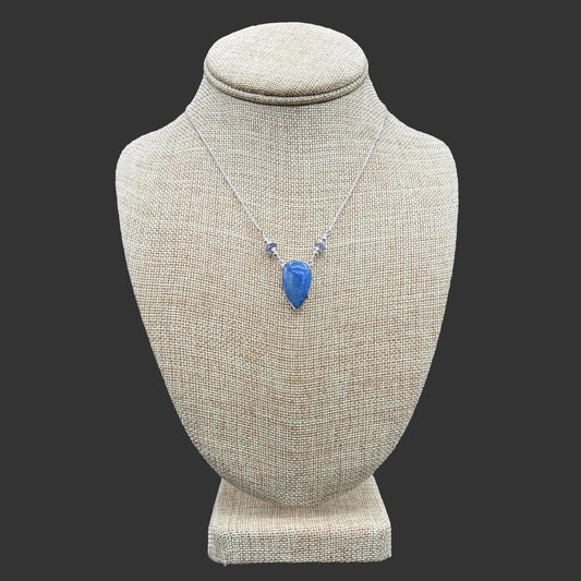 Front view of this sterling silver blue dumortierite and iolite necklace, in front of a black background.