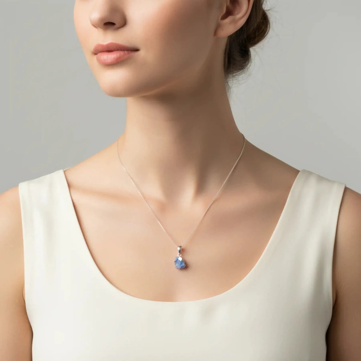 Sterling Silver and Dumortierite Pendant necklace on a lady's neck.