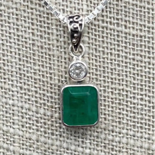Close Up Of Green Emerald And Small Diamond Pendant