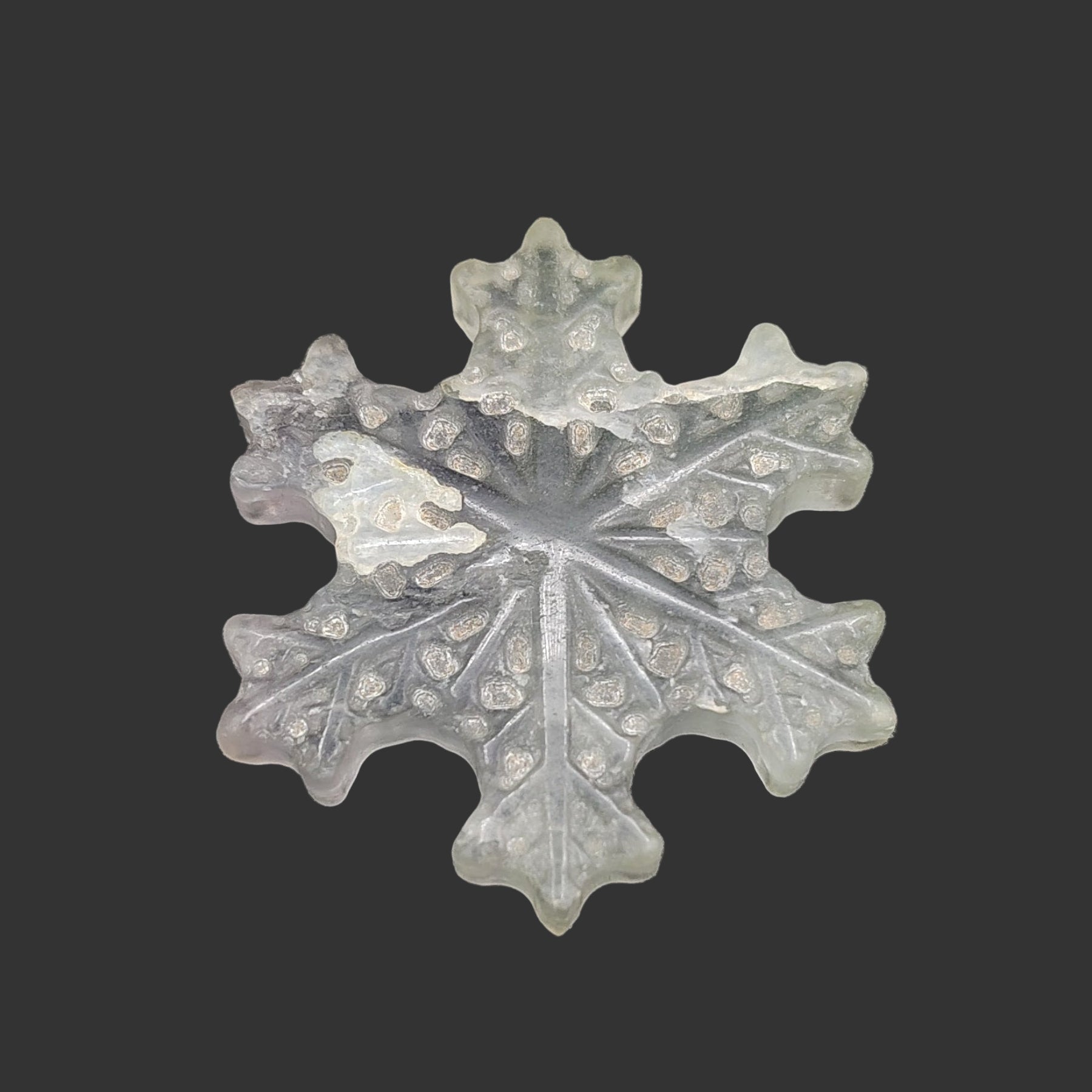 This is the face of this light green fluorite snowflake.
