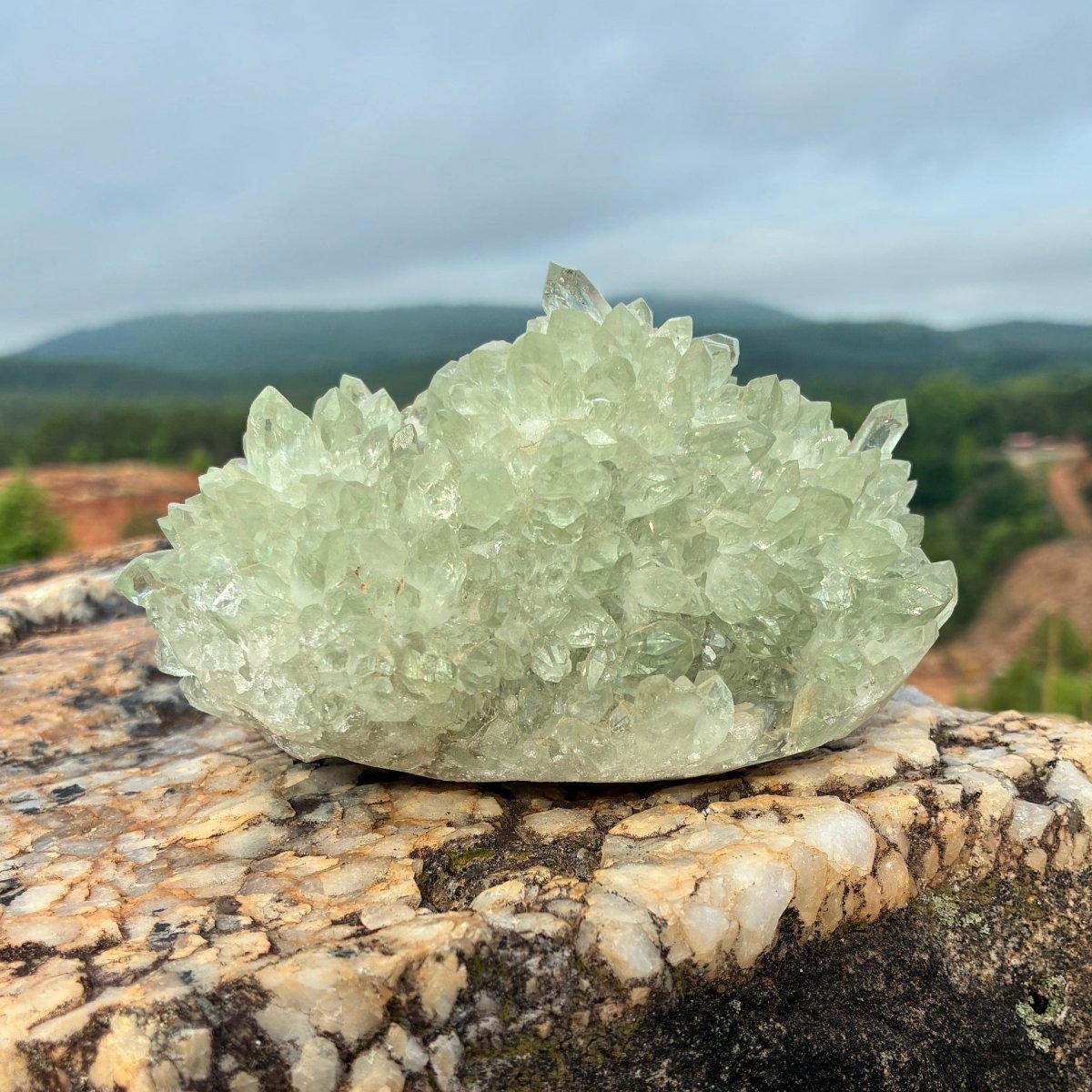 Back side of this green quartz stalagmite cluster, on a boulder outdoors.