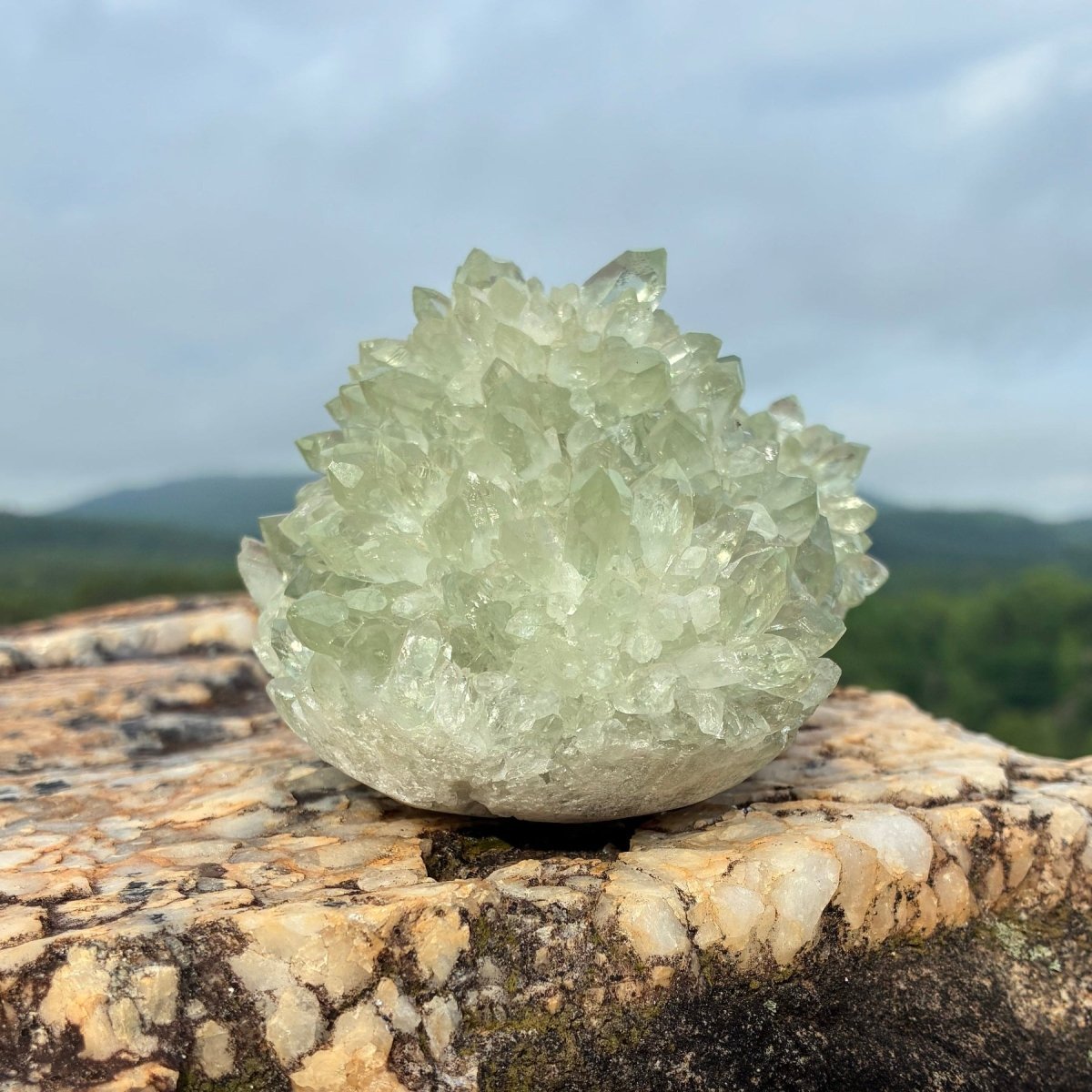 Right side of this green quartz stalagmite cluster, on a boulder outdoors.