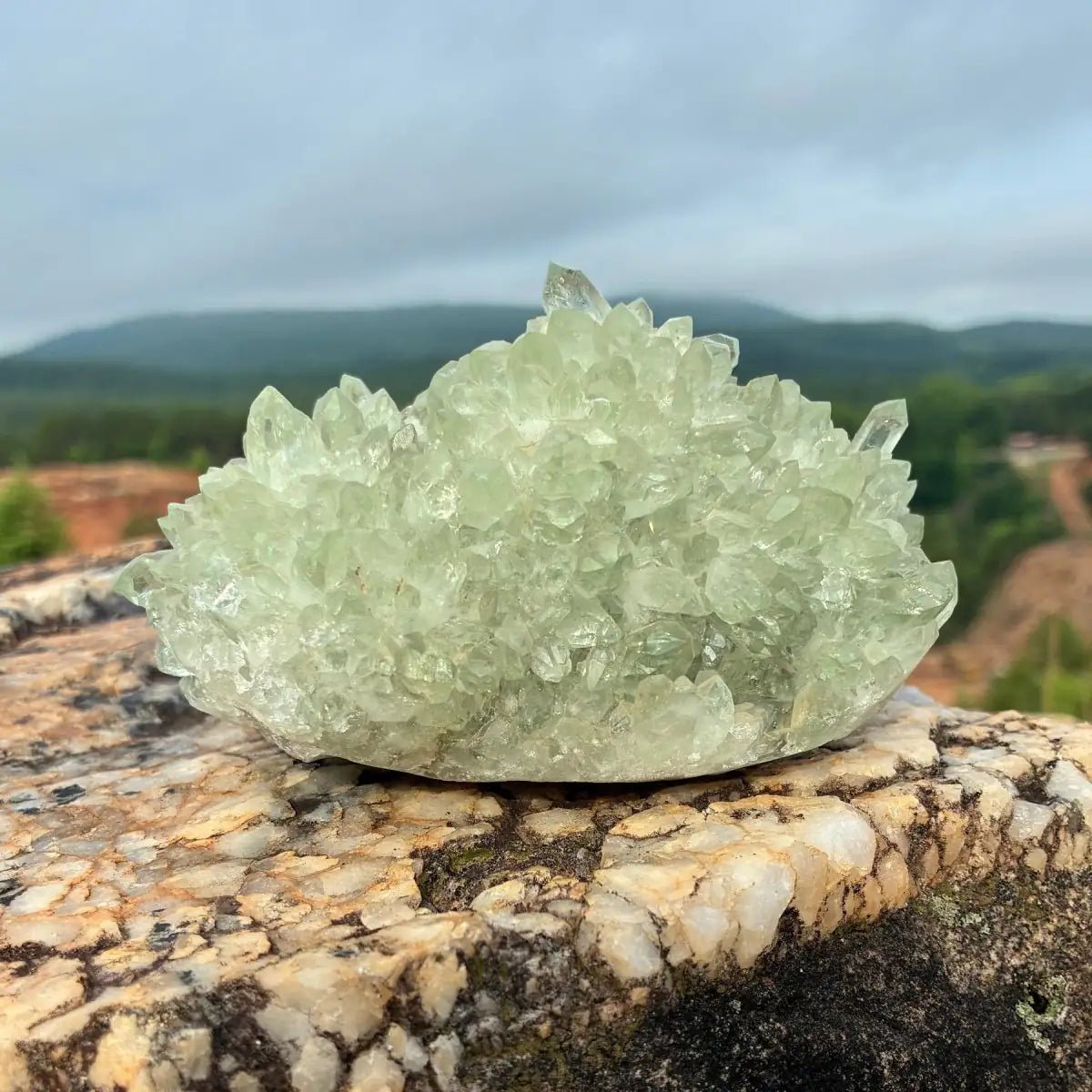 Back side of this green quartz stalagmite cluster, on a boulder outdoors.