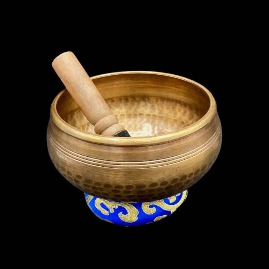 Hammered Copper Singing Bowl sitting on a donut cushion with mallet inside