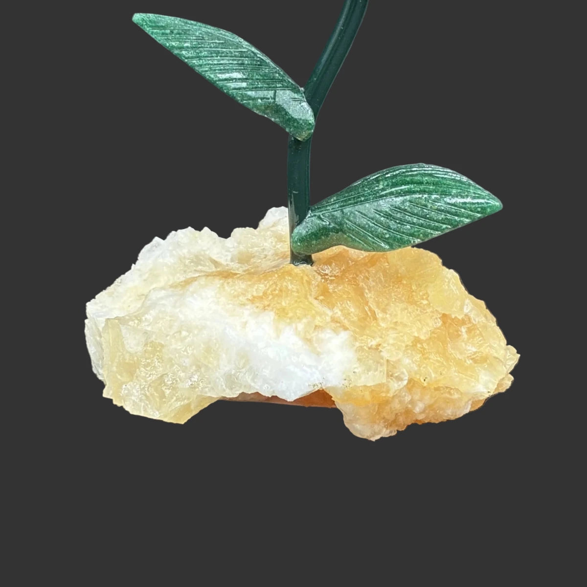 Close up of the orange calcite base, in front of a black background.