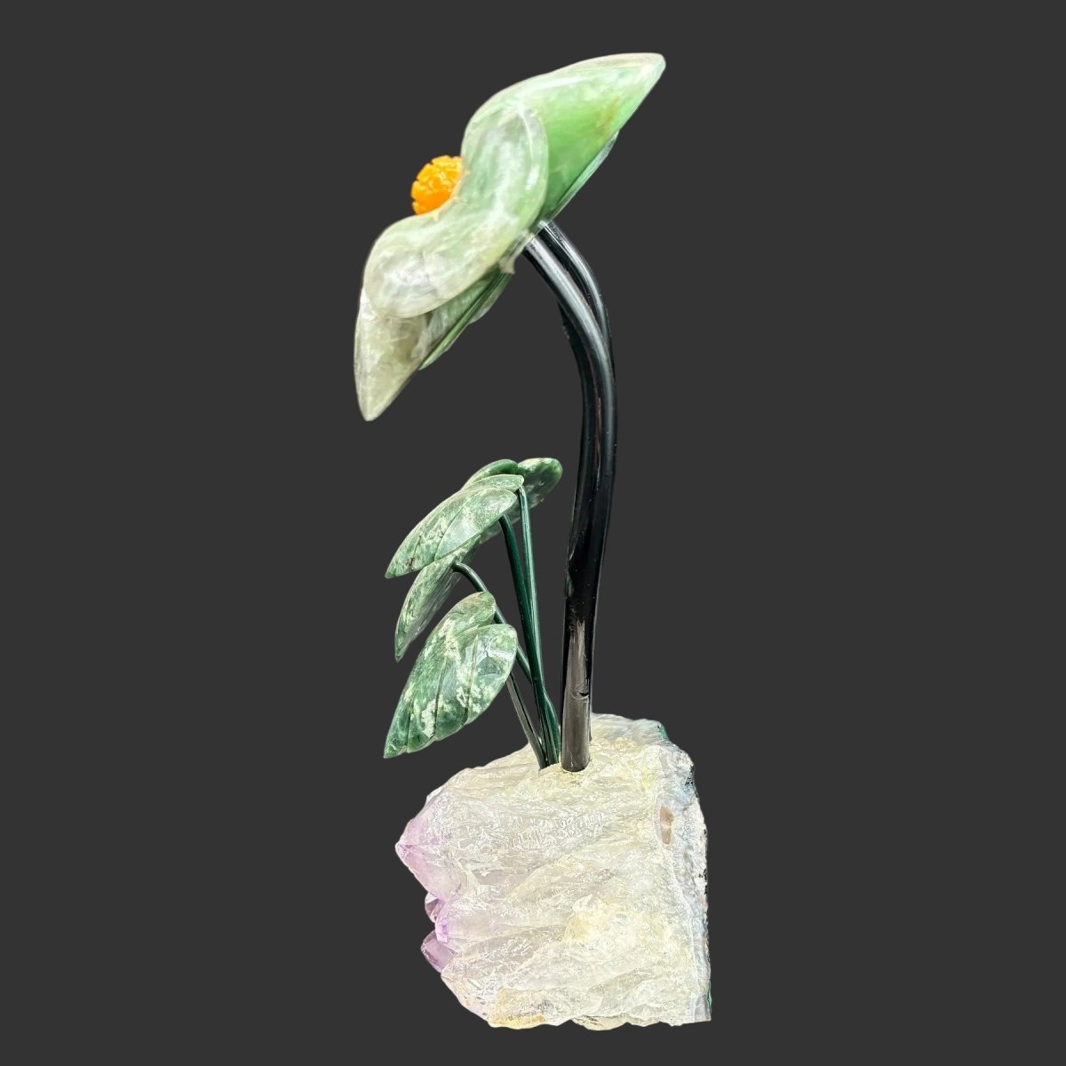 Side view of this double fluorite daisy on a purple Amethyst base, in front of a black background.