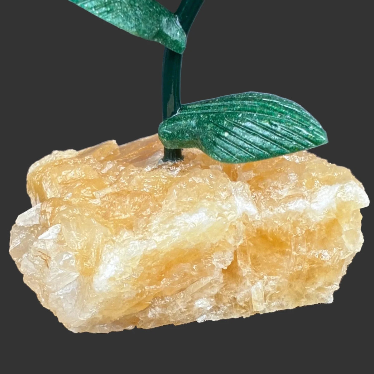 Close up of the yellow Calcite base, in front of a black background.