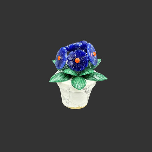 Front view of this mini sodalite gemstone flowerpot, in front of a black background.